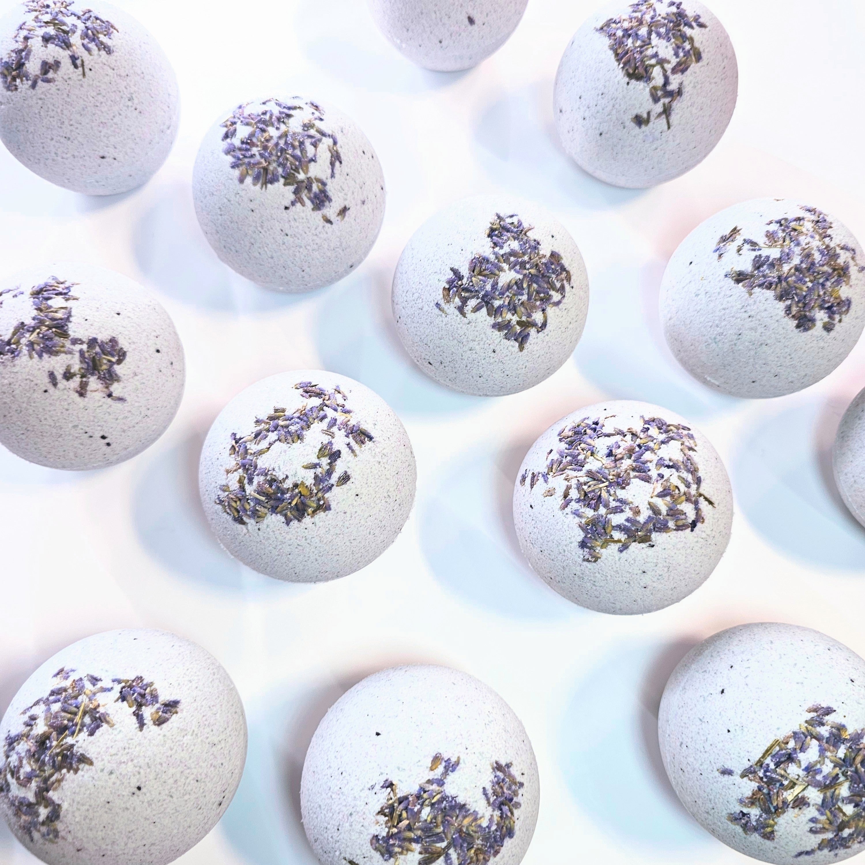 Light Blue Bath bombs with lavender flowers on a white background